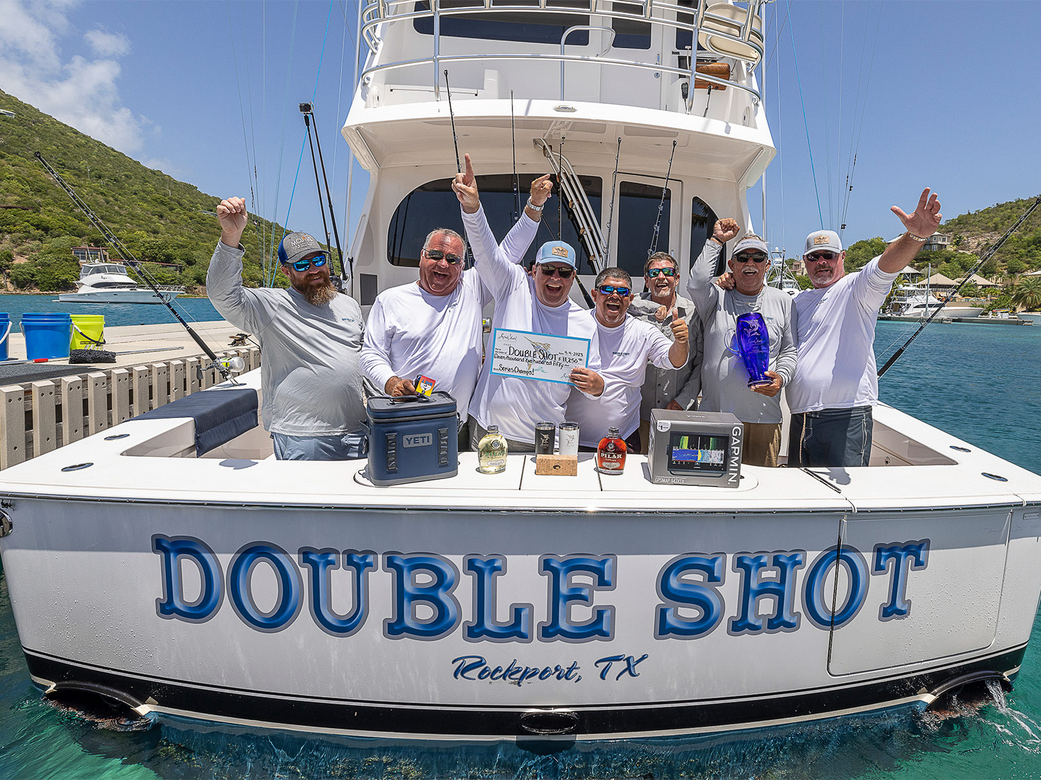 Team Double Shot celebrating a win in the cockpit of their sport-fishing boat.